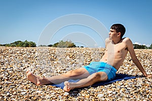 Sunbathing on a stoney beach