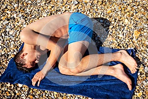 Sunbathing on a stoney beach