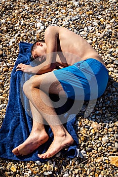 Sunbathing on a stoney beach
