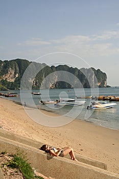 Sunbathing woman krabi beach thailand