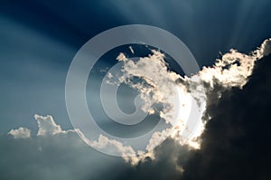 Sunbeam through the black stormy cloud