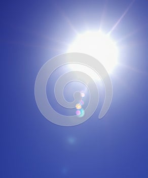 Sunbeam through the haze on blue sky, vertical