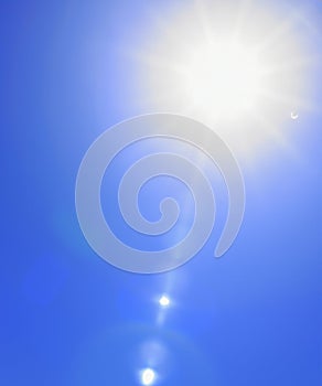 Sunbeam through the haze on blue sky, vertical