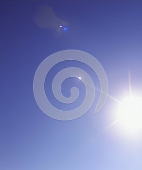 Sunbeam through the haze on blue sky, vertical