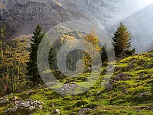 Sunbeam in harsh mountain valley by fall colors