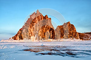 Sunbeam over Shamanka Rock near Khuzhir in late winter in evening sunset time.