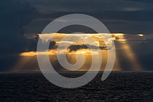 Sunbeams through clouds off coastal Alaska