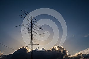 Sunbeams among the clouds over an antennae