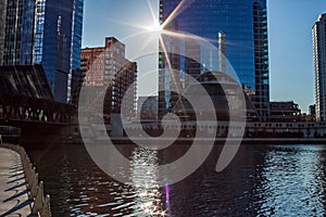 Sunbeams extend over the Chicago River and cast tiny beam of lights onto the water ripples