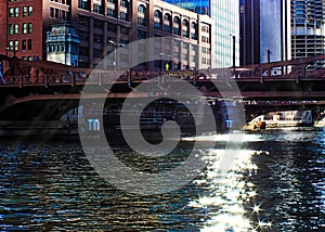 Sunbeams extend over the downtown Chicago Loop, creating glittering stars on the river during morning photo