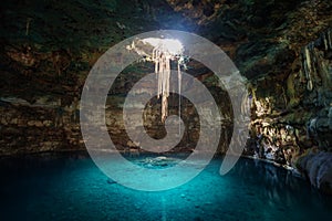 Sunbeams penetrating in opening of Blue cenote photo