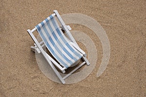 Sunbed laying on very fine sand in portrait flat lay with copy space in landscape mode