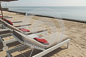 Sunbeds on beach near sea