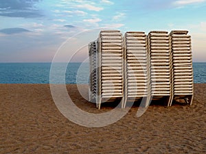 Sunbeds on deserted beach