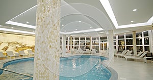 Sunbeds in the indoor swimming pool. Move camera footage