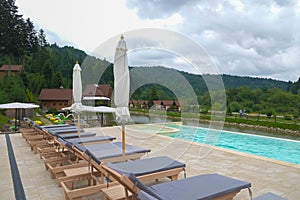 Sunbeds with mattresses near the pool in the Ukrainian Carpathians