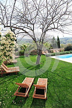 Sunbeds next to a swimming pool in garden