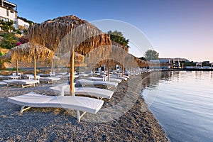 Sunbeds with parasols at Mirabello Bay