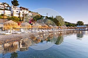 Sunbeds with parasols at Mirabello Bay on Crete