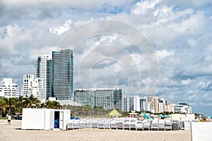 Sunbeds stacked on sand beach