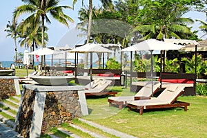 Sunbeds in tropical resort hotel