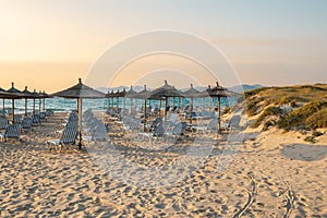 Sunbeds with umbrella on sandy beach of Kos island.