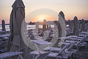 Sunbeds and umbrellas on the beach at sunset #3