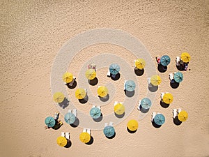 Sunbeds and umbrellas on hot sand