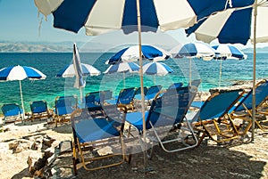 Sunbeds and umbrellas (parasols) on the beach in Corfu Island, Greece