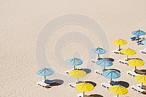 Sunbeds with umbrellas on the sandy beach