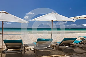 Sunbeds and umbrellas on a white sand beach