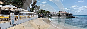 Sunbeds under umbrellas on the beach, panorana