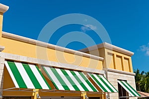 sunblind awning on the building. striped sunblind awning. sunblind awning on window.