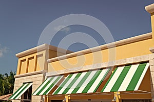 sunblind awning on the building. striped sunblind awning. sunblind awning on window.