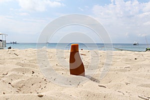 Sunblock bottle at the beach photo