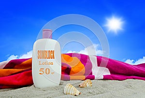Sunblock lotion and towel photo