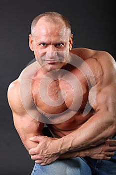 Sunburnt bodybuilder wearing in jeans