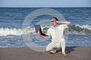 Sunburnt man with phone and laptop