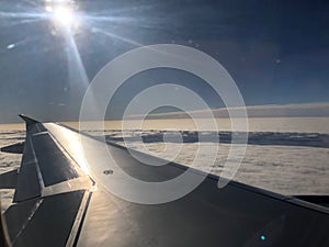 sunburst over airplane wing