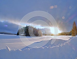 Sunburst over a frozen lake near Kemijarvi Finland