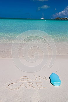 Suncare written on tropical white sand and