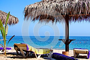 Sunchair and umbrellas on the sea beach