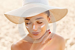 Suncream. Suntan Lotion Beautiful Woman Applying on beautiful on Face. Sunscreen Solar Cream. Skin care photo