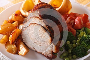 Sunday roast: pork with vegetables and Yorkshire pudding. Horizo