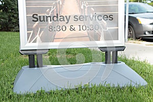 sunday services 830 and 1030 time sign information on grass lawn 53 p 17 h