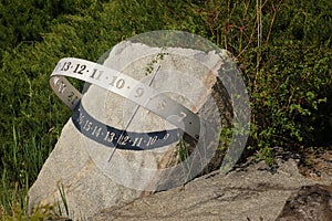 Sundial indicating noon, stone, metal, sun and shade