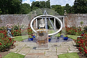 Sundial and The statue of John Flamsteed at Herstmonceux Castle in England