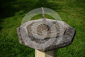 Sundial on stone plinth with inscription `tempus fugi` latin for time flies