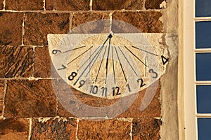 Sundial on a wall of the historic church in Rodenkirchen, Germany