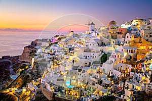 Sundown evening view of traditional Greek village Oia on Santorini island in Greece. Santorini is iconic travel destination in